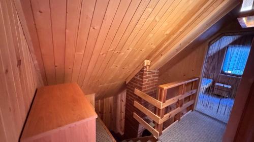 an attic room with a staircase in a house at Jaśminowy ogród in Brenna