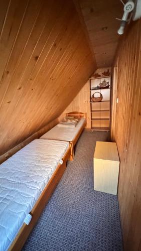 a small room with a bed and a table at Jaśminowy ogród in Brenna