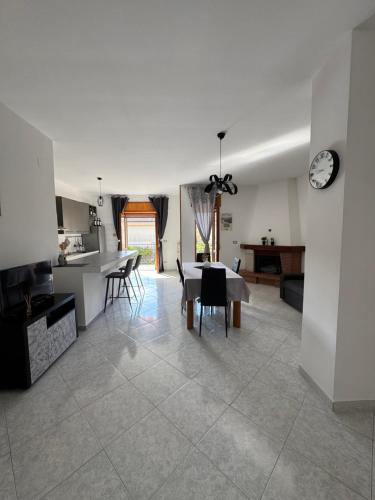 a kitchen and living room with a table and chairs at G&N apartment in Agropoli