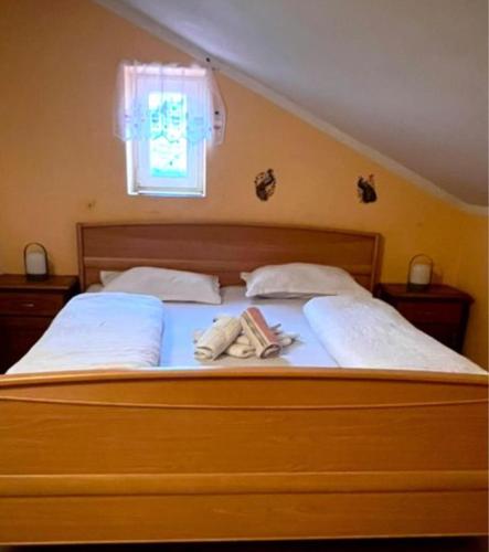 a bedroom with a bed with two towels on it at Răsfăț cazare in Focşani