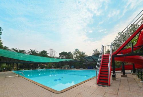 a large swimming pool with a red slide at Mina Resort and Spa in Loei