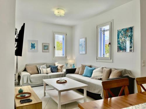 a living room with a couch and a table at Villa Santorini Serenity with private Pool in Monolithos