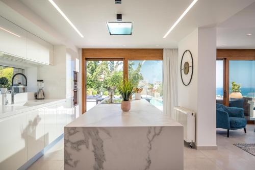 a kitchen with a large marble counter top in a room at Eunoia Blue Villa Heraklion Crete, Sea View, Private Pool, Prassas, Karteros in Prasás
