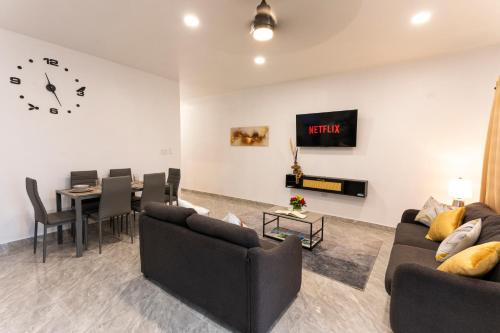 a living room with two couches and a dining room at Spacious 2 Bedroom Unit with Concierge in Anguilla