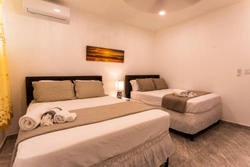 two beds in a small room with two beds at Spacious 2 Bedroom Unit with Concierge in Anguilla