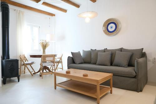 a living room with a couch and a table at Senza's Cycladic Home in Marpissa , Paros in Kampos Paros