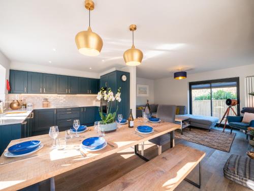 a kitchen and living room with a wooden table at Redwalls Luxury House in Dartmouth