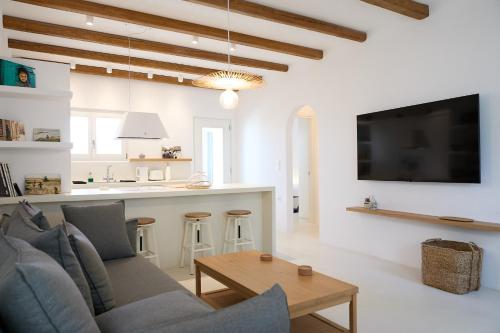 a living room with a couch and a table at Senza's Cycladic Home in Marpissa , Paros in Kampos Paros