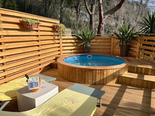 a wooden deck with a hot tub in a backyard at Wild Wild Nest Sperlongaresort in Sperlonga