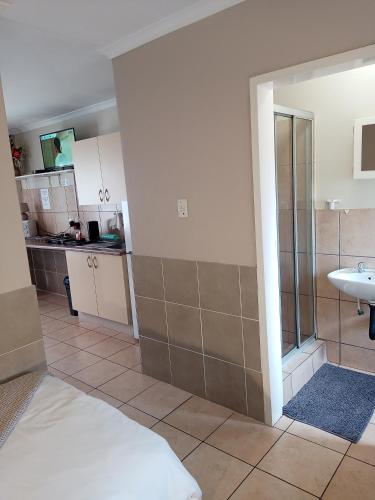 a bathroom with a shower and a sink in a room at Accommodation@Park1285 in Pretoria
