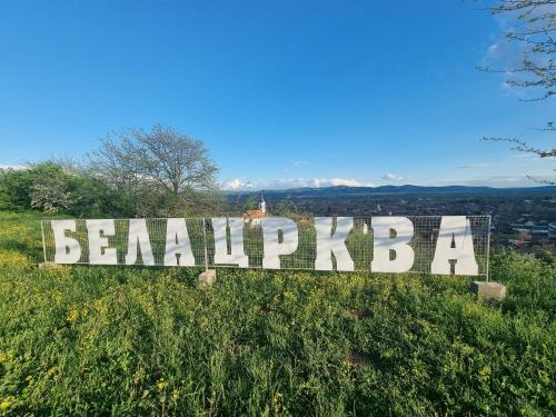 a sign on top of a grass covered hill at BIG APARTMAN BELA CRKVA in Bela Crkva