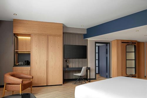 a hotel room with a bed and a desk at Four Points by Sheraton Istanbul Pendik in Istanbul