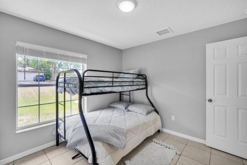 a bedroom with a bunk bed and a window at Relax & Recharge in Sunny Inverness home in Inverness