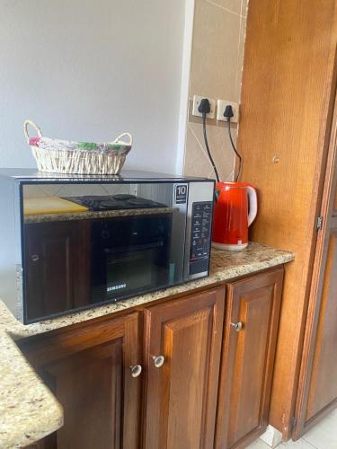 a microwave oven sitting on top of a kitchen counter at Wonderful Guest house in Durban
