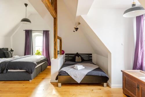 a bedroom with two beds and purple curtains at Wohnen wie im Schloss - Alter Bahnhof von Kruft in Kruft