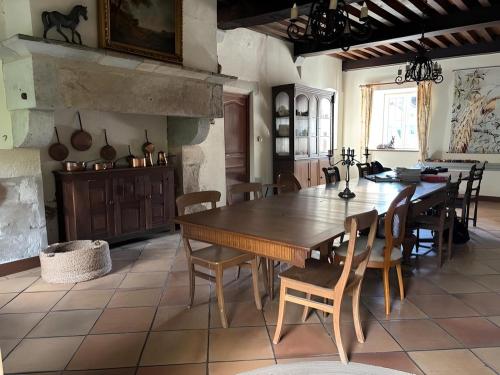 a dining room with a large wooden table and chairs at Castel Rochefort sur Nenon Jura in Rochefort-sur-Nenon