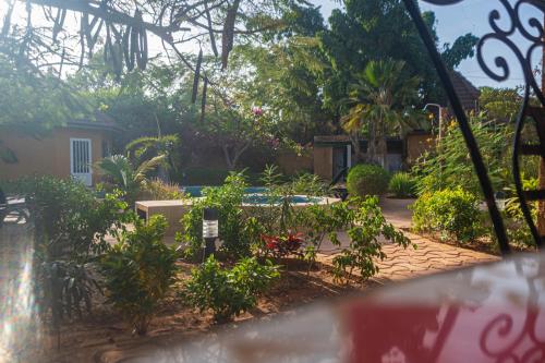 a garden with plants and a house in the background at Charming Vacation House in Ngaparou