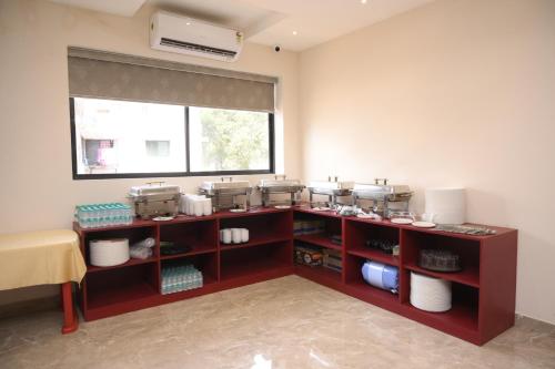 a kitchen with a counter with pots and pans at Zip By Spree Hotels Neelam Nakshatra in Kudal