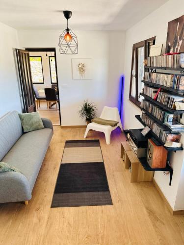 a living room with a couch and a book shelf at Milton holiday house in Blato