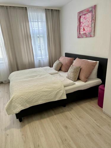 a bedroom with a large bed with pillows on it at Altstadt-Hotel Gosequell in Goslar