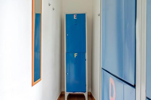 a row of blue lockers in a room at A Casa di Amici in Palermo