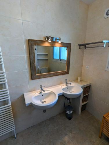une salle de bain avec deux lavabos et un miroir dans l'établissement Magnifique maison avec piscine, idéalement située, à La Teste-de-Buch