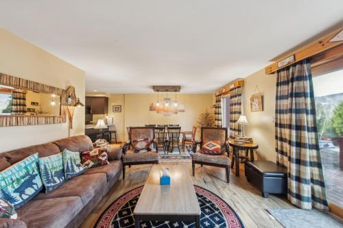a living room with a couch and a table at Straight Brook 5D - Adirondack-Style Townhome in North Creek