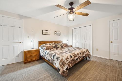 a bedroom with a bed and a ceiling fan at Hudson 76I - A Stylish Mountain Retreat in North Creek