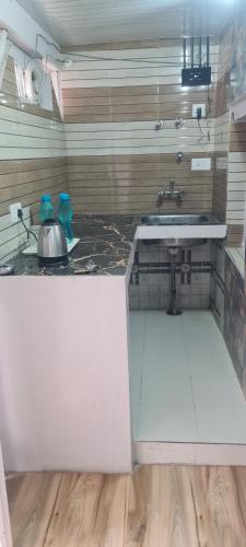 a kitchen with a sink and a counter top at The Heritage jasmine lodge B&B in Shimla