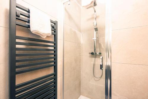 a shower with a glass door in a bathroom at Spring Lake 43, Jesse-Belle P in South Cerney