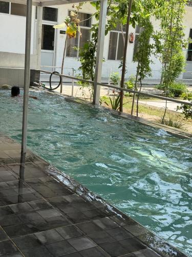 a pool of water in front of a house at Sir Mam Ashram in Bhaddi