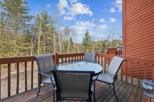 a table and chairs on the deck of a house at Twin Fawns in North Creek