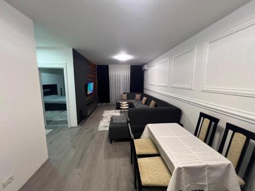 a living room with a couch and a table at Siar Apartament in Prizren
