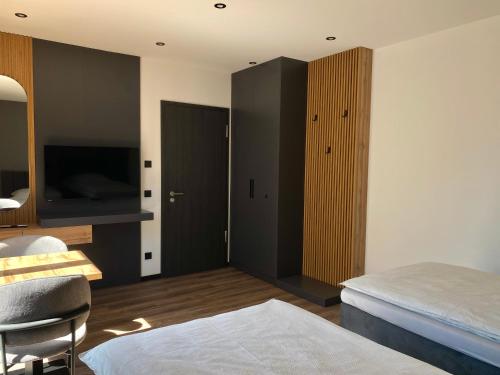 a room with a bedroom with a bed and a tv at A & B Apartment und -Zimmervermietung in Tornesch
