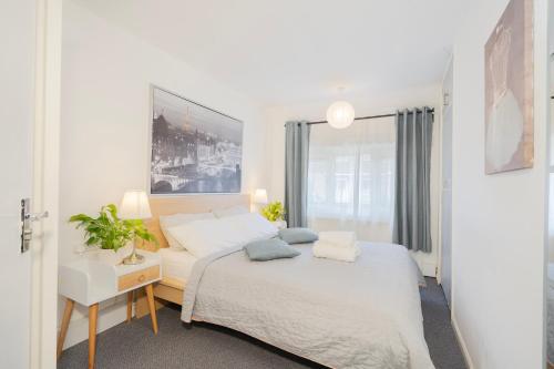 a bedroom with a bed and a desk and a window at Entire 4-Bed House & Parking, Steps from ICC & Utilita Arena Birmingham & Broad Street in Birmingham