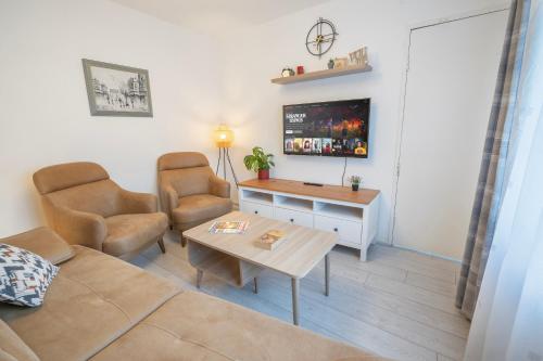 a living room with a couch and a table at Entire 4-Bed House & Parking, Steps from ICC & Utilita Arena Birmingham & Broad Street in Birmingham