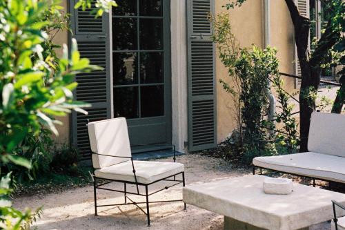 a pair of chairs and a table in front of a building at Hôtel du Couvent, a Luxury Collection Hotel, Nice in Nice