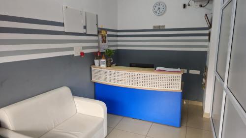 a office with a desk and a chair in a room at Pondy Pleasant Stay in Puducherry