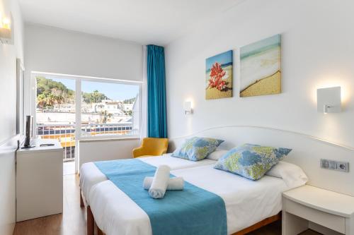 Postel nebo postele na pokoji v ubytování Hostal Neptuno