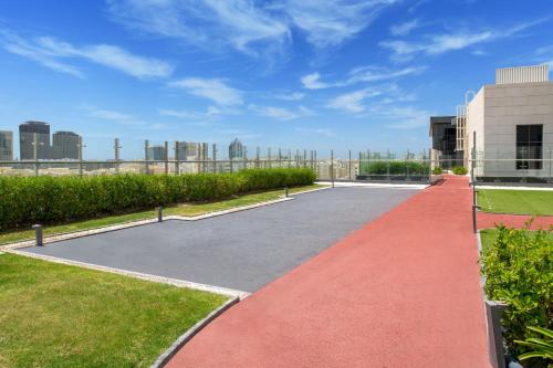 a basketball court in front of a building at Marriott Executive Apartments Doha, Le Mirage City Walk in Doha