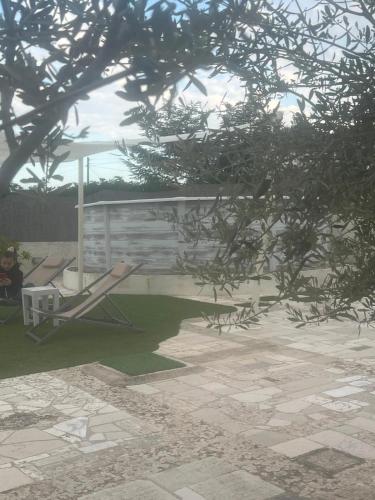 a patio with a bench and a gazebo at Trullo Monticello in Martina Franca
