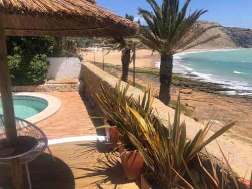 a resort with a swimming pool and a beach at Beach front/waterside apartment in Luz