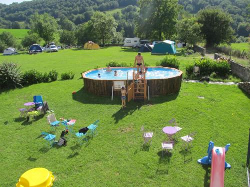 a man and a child standing in front of a pool at Goute la vie in Marchamp