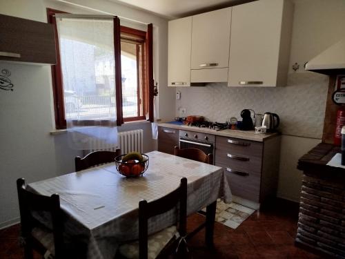 a kitchen with a table with a bowl of fruit on it at Casa Eben-Haezer in Fiumana