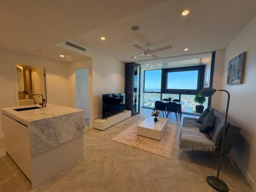 a living room with a couch and a table at 61F Skyline Retreat City River BotanicGarden View in Brisbane