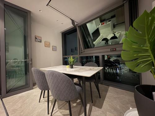 a dining room with a table and chairs and a fireplace at 61F Skyline Retreat City River BotanicGarden View in Brisbane