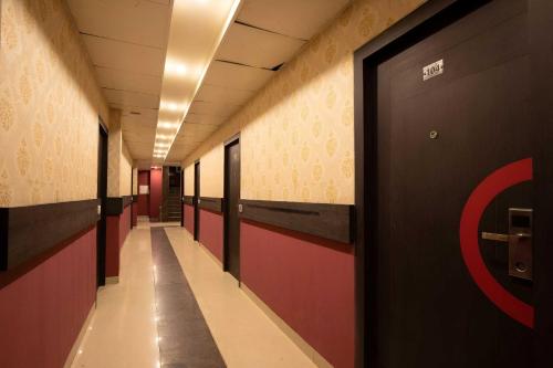 a corridor of a hallway with a door in a building at Collection O Kumaranalloor Formerly San Jose Inn in Pāmbādi