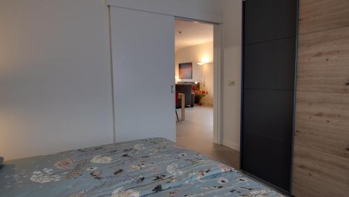 a bedroom with a bed and a sliding door at Vakantiehuisjes "De Veldzijde" in Losser