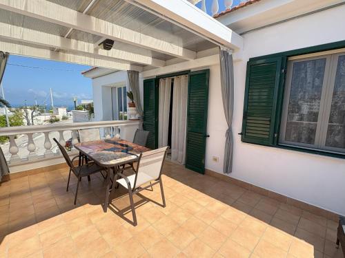 a patio with a table and chairs on a balcony at Sunderville Superior in Peschici