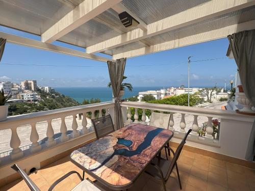 a balcony with a table and chairs and the ocean at Sunderville Superior in Peschici